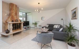 a living room with a couch and a fireplace at Villa Green Castle in Zadvarje