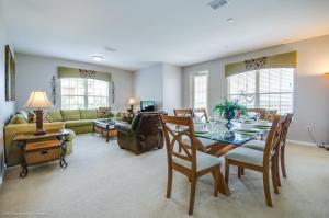 a living room with a table and a couch at LAKEVIEW Condo at Vista Cay Resort in Orlando