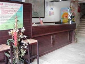 a reception desk with two chairs and a podium at GV Hotel - Cagayan de Oro in Cagayan de Oro