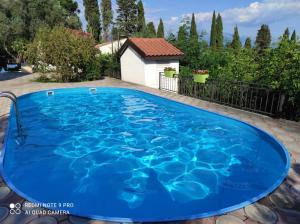 a large blue swimming pool in a yard at Mio Lux in Baošići