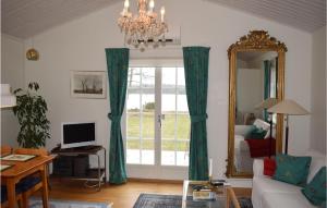 a living room with green curtains and a mirror at Nice Home In Vxj With 2 Bedrooms And Wifi in Växjö