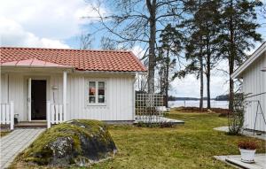 a small white house with a red roof at Nice Home In Vxj With 2 Bedrooms And Wifi in Växjö