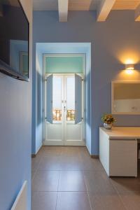 a hallway with a door with a view of the ocean at Al Duomo B&B in Amantea