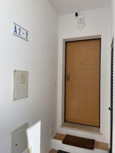una porta in una stanza con un cartello sul muro di Apartamentos Santa Teresinha ad Alvor
