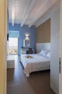 a bedroom with a large bed with a blue wall at Al Duomo B&B in Amantea