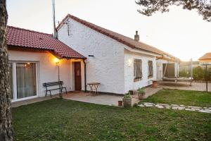 a white house with a patio and a table at Casa Urbión-Pinares de Soria in Covaleda