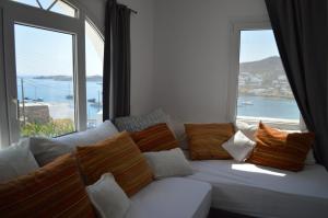 a white couch in front of a large window at Revel Mykonos 4 in Mýkonos City