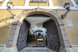 an archway into a building with a mitzvah sign on it at Academy Pension in Budapest
