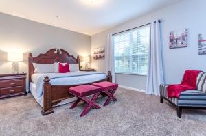 a bedroom with a bed and a chair and a window at Spacious Condo in Vista Cay Resort LUXURY AWAITS in Orlando +58 photos