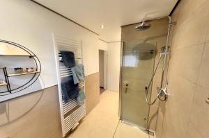 a shower with a glass door in a bathroom at Ferienwohnung Hamm-Osten in Hamm