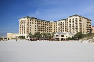 a large hotel on the beach with a white beach at Sandpearl Residences 606 in Clearwater Beach