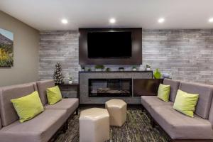 a living room with a couch and a fireplace at Best Western North Phoenix Hotel in Phoenix