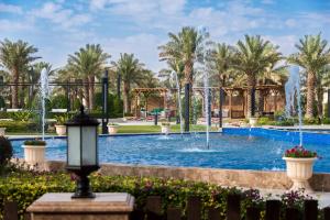 a pool with fountains in a park at Dorat Najd Resort in Riyadh