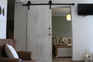 a white door in a living room with a chair at Kassiani House in Theológos +7 photos