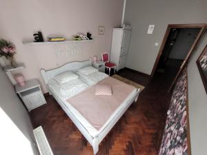 a small bedroom with a bed and a red chair at Old Town Apartment in Gdańsk