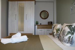 a bedroom with a bed with towels on it at Kassiani House in Theológos