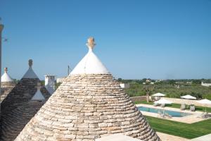 a view from the roof of a resort with a swimming pool at Dimore Angiulli - Trulli di Charme in Castellana Grotte