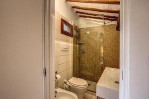 a bathroom with a toilet and a shower and a sink at Magenta Collection Moro 4 in Rome