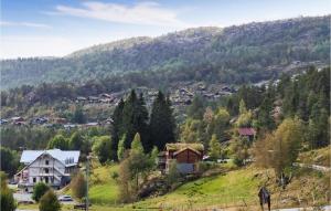 a village on a hill with houses and trees at Stunning Home In Fossdal With House A Panoramic View in Fossdal