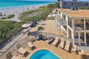 a balcony with chairs and a swimming pool next to the beach at Belleair Beach Club 315 in Clearwater Beach