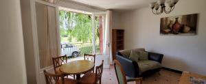 a living room with a table and chairs and a couch at Beautiful 4 bedroom property near to Monflanquin in Laussou