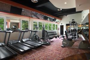 a gym with treadmills and elliptical machines at ASTON Manado Hotel in Manado