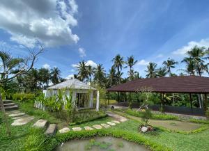 a house with a garden and a gazebo at Hot Stone Club Ubud in Ubud