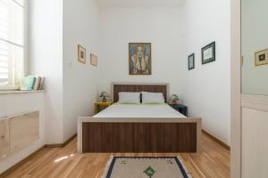 ein Schlafzimmer mit einem Bett in einem Zimmer in der Unterkunft CENTRAL CATHEDRAL APARTMENT in Kotor