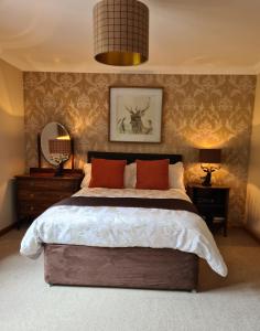 a bedroom with a large bed with red pillows at Creag-Ard Bed & Breakfast in Dundonnell