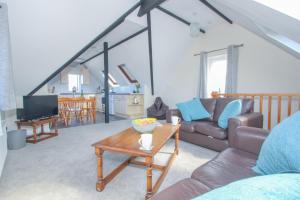 a living room with a couch and a table at The Laurels Cottages nr Padstow and Wadebridge in Wadebridge