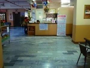 a restaurant with a counter in the middle of a room at GV Hotel - Davao in Davao City