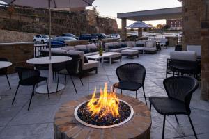 a fire pit on a patio with chairs and tables at Hyatt Place Dallas/Rockwall in Rockwall