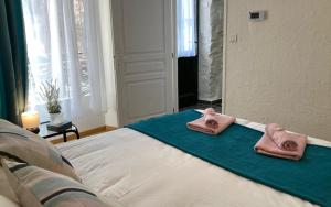 ein Bett mit zwei Handtüchern darüber in der Unterkunft Centre Vaison-la-Romaine, Appartement T2 in Vaison-la-Romaine