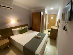 a bedroom with a bed with a towel on it at Baskent Otel in Didim