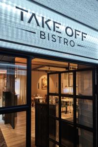 a take off bistro sign on the front of a restaurant at Konvin Hotel by Reykjavik Keflavik Airport in Keflavík