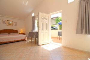 a bedroom with a bed and a door leading to a patio at Studio in Porec/Istrien 10215 in Poreč