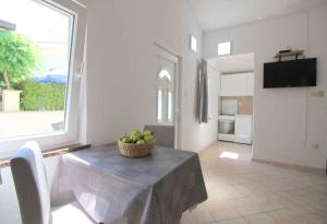 a dining room with a table with a bowl of fruit on it at Studio in Porec/Istrien 10215 in Poreč