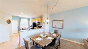 a dining room and kitchen with a table and chairs at Lovely Townhome at Vista Cay Resort near WDW in Orlando