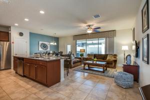 a kitchen and living room with a couch and a table at Townhome wPrivate Pool & FREE on-site Water Park in Kissimmee