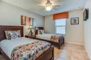 a bedroom with two beds and a ceiling fan at Townhome wPrivate Pool & FREE on-site Water Park in Kissimmee +38 photos