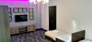 a small room with a bed and a tv at TAMAZI in Kobuleti