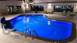 a large blue swimming pool in a hotel room at Holiday Inn Express & Suites Williamsport, an IHG Hotel in Williamsport