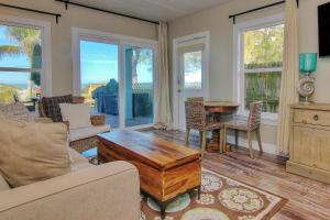 a living room with a couch and a table at Bungalow Beach Place 4 in Clearwater Beach