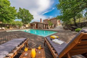 a swimming pool with a table and chairs next to a house at Villa Stone House Magarac in Seline