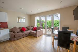 a living room with a couch and a table at Helena Cottage in Elie