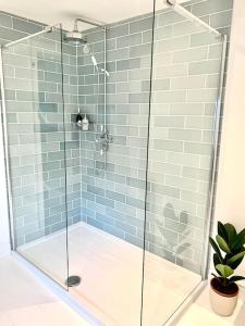 y baño con ducha y puerta de cristal. en Stunning 3 bed house in the heart of Cheltenham, en Cheltenham