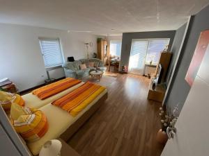 a bedroom with a large bed and a living room at Ferienwohnung Chaves in Bad Karlshafen