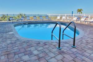 a small swimming pool with chairs and a rail at Belleair Beach Club 312 in Clearwater Beach
