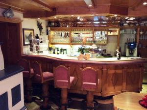 a bar in a restaurant with chairs around it at Der Klaushof in Mayrhofen