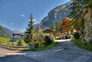 uma estrada que leva a um alojamento de turismo selvagem nas montanhas em Der Klaushof em Mayrhofen